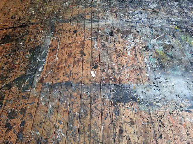 Studio floor used by Jackson Pollock at the Pollock-Krasner House and Study Center in Springs, New York. The studio is in an old barn behind the house. Pollock had the building moved, put a wood floor down and used it as his primary painting surface from 1946 until his death in 1956. When he renovated in 1953, he put down a masonite covering. Krasner started to use the room in 1957. Upon her death in 1984, ownership was transferred to Stony Brook University, who removed the covering, discovered the old surface, and had it restored in 1987-8. Credit: Rhododendrites