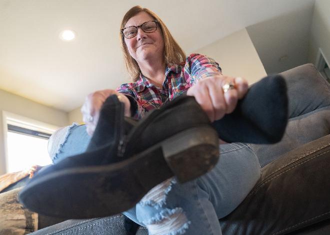 Aimee Kain used to have trouble putting on her favorite boots because of chemotherapy-induced neuropathy. After participating in the dance therapy program, she can do normal daily activities. Credit: The Ohio State University Comprehensive Cancer Center