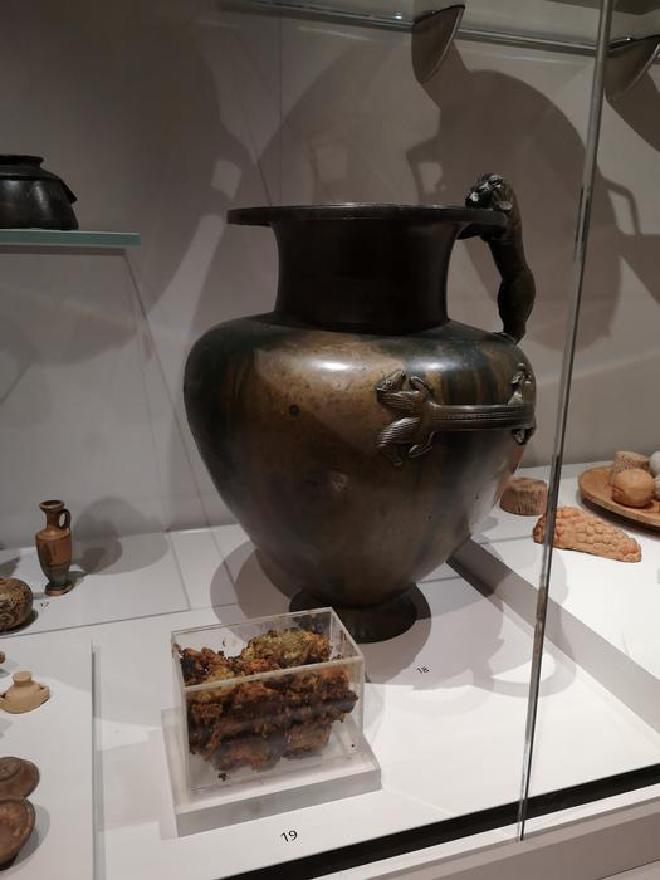 The bronze jar on display at the Ashmolean Museum contained a mysterious substance (shown in the foreground) that is very likely ancient honey.